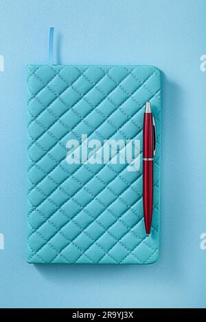 Blue Notepad And Red Ballpoint Pen Stock Photo