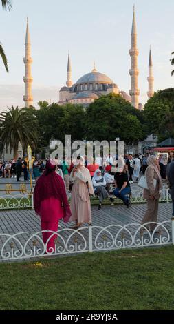 Tourists taking a photo in the gardens with the Sultan Ahmed Mosque aka Blue Mosque Sultanahmet neighbourhood, Istanbul, Turkey Stock Photo