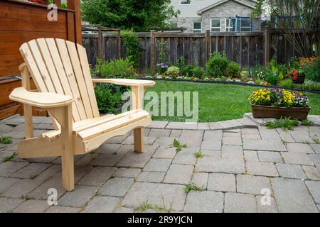 Garden chair made of natural pine in the backyard Stock Photo