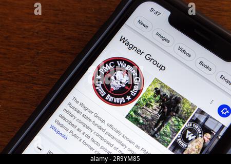 Google search result of Wagner Group seen in an iPhone. The Wagner Group is a Russian state-funded paramilitary organization (PMC Wagner) Stock Photo