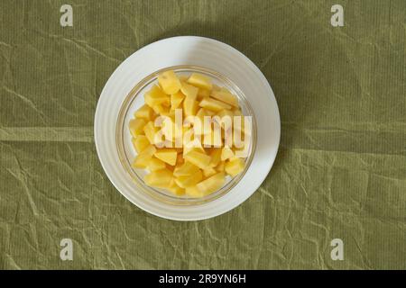 chopped potatoes in a plate on a table in the kitchen Stock Photo