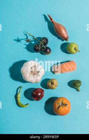 Vegetable and sushi still life shot from above on a blue background Stock Photo