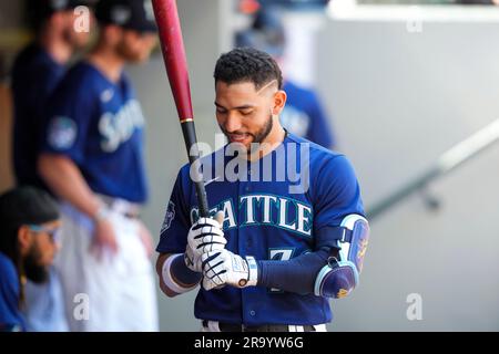 Seattle Mariners' Jose Caballero holds a trident in the dugout as teammates  dump sunflower seeds on his head as he celebrates hitting a three-run home  run against the Oakland Athletics in a