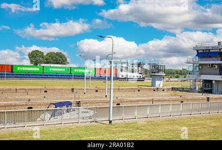 Stuw- en sluizencomplex Sambeek, Netherlands - July 9. 2023: Maas river sluis with inland waterway cargo container ship Stock Photo