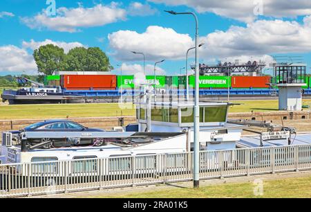 Stuw- en sluizencomplex Sambeek, Netherlands - July 9. 2023: Maas river sluis with inland waterway cargo container ship Stock Photo