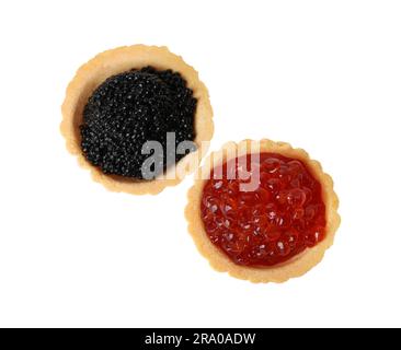 Delicious tartlets with red and black caviar on white background, top view Stock Photo