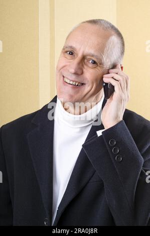 Happy businessman having good news on mobile phone Stock Photo