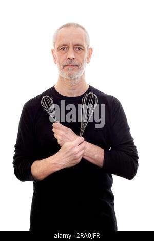 Adult man in black holds a whip in each and looks serious Stock Photo