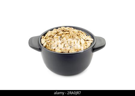 Oat flakes in a little black ceramic dish Stock Photo