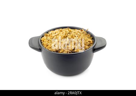 Fragrant natural dry chamomile in a black ceramic dish Stock Photo