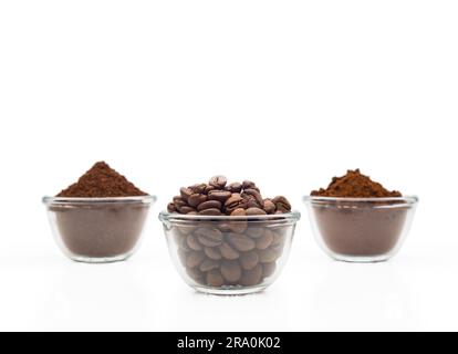 Coffee beans, ground coffee and instant coffee, in little glass cups on a clean white background Stock Photo