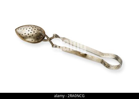 An antique tea strainer in silver metal Stock Photo