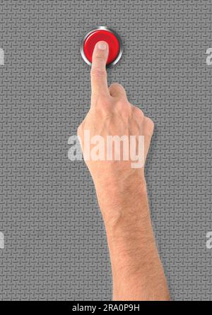 A man pushing a big red start stop alarm button with the finger Stock Photo