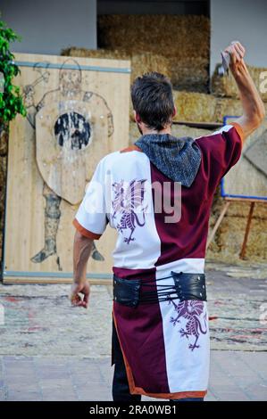 Man in medieval dress, axe throwing, market, throws axe, demonstration at medieval market, La Nucia, Altea, Costa Blanca, Spain Stock Photo