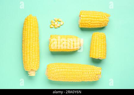 Fresh corn cobs and seeds on turquoise background Stock Photo