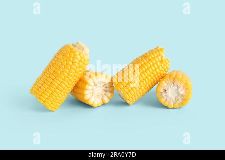 Cut fresh corn cobs on blue background Stock Photo