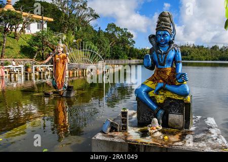 Right Sculpture Figure Statue of Hindu God Hindu Deity Shiva of Hindu Religion Left Woman Wife of Shiva Parvati in Lake Sacred Hindu Lake Ganga Stock Photo