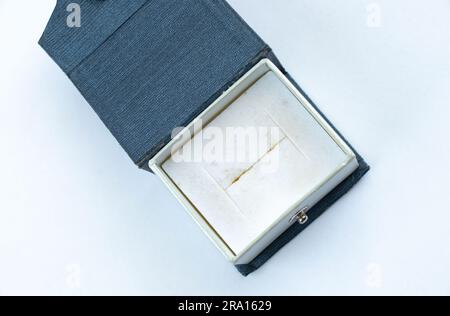empty cardboard dirty blue box for a ring on a white Stock Photo