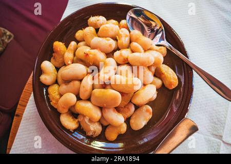 Fasule pllaqi – a vegetarian Albanian dish, giant lima / butter beans baked in tomato sauce, served at a restaurant in Tirana Stock Photo