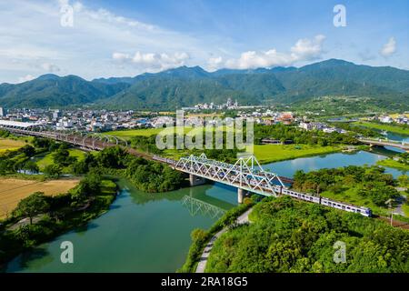 Train pass the iron bridge at dongshan river eco park in yilan, taiwan Stock Photo