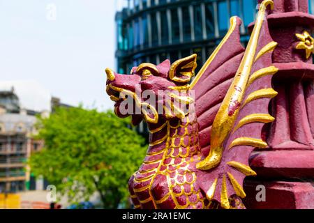 Red and gold dragon guarding a street lamp on the Holborn Viaduct, London, England, UK Stock Photo