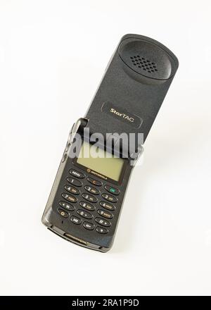 Motorola Startac, open mobile phone from the 90s, a technological icon that has made the history of mobile telephony in the world. Stock Photo