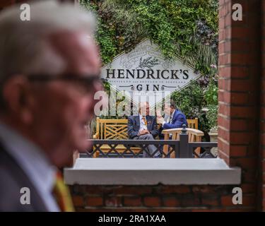 Two Marylebone Cricket Club members talking about the game in the members garden during the LV= Insurance Ashes Test Series Second Test Day 3 England v Australia at Lords, London, United Kingdom, 30th June 2023  (Photo by Mark Cosgrove/News Images) Stock Photo