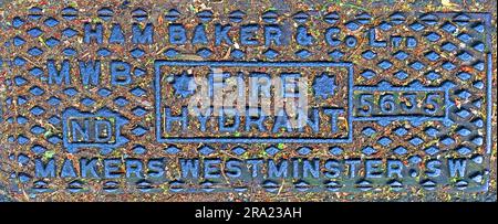 Close-up of a cast iron London street hydrant plate marked “Ham Baker & Co Ltd MWB Fire Hydrant 5635 ND Makers Westminster SW” Stock Photo