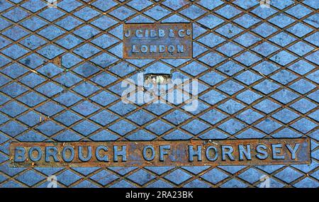 Close-up of a cast iron street grid stamped “Borough of Hornsey” and “J Gibb & Co, London” Stock Photo