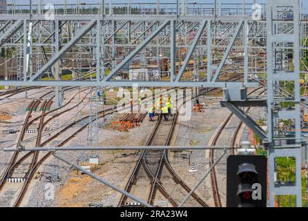 Moscow, Russia. June 30, 2023. Builders of the railway station workers laying the rails. Construction of the station. Stock Photo