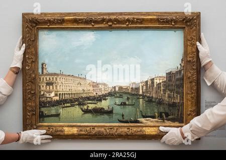 London, UK.  30 June 2023. Technicians present “Venice, a view of the Grand Canal looking north from near the Rialto Bridge, with the Fabbriche Nuove on the left” by Bernardo Bellotto (Est. £2,000,000 - 3,000,000) at a preview of highlights Sotheby’s Old Masters & 19th Century Paintings Summer Sales.  Works will be auctioned at Sotheby’s New Bond Street galleries 5 to 7 July.   Credit: Stephen Chung / Alamy Live News Stock Photo