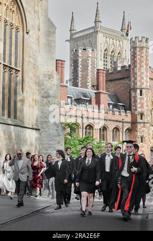 Led by staff, students from Magdalene College, University of Cambridge, England, process past St John's College to Senate House for their graduation award ceremony on Friday 30 June 2023. Stock Photo