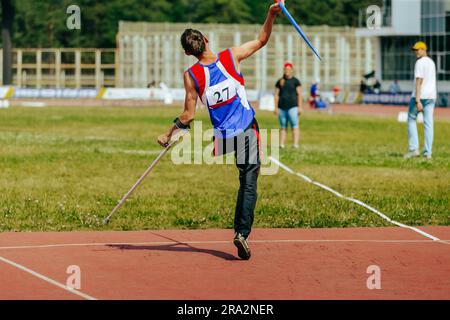 male athlete without leg with crutch javelin throw at athletics championships, summer sports games Stock Photo