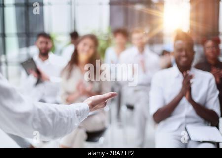 Selective focus of lecturer talking to audience during seminar in conference room Stock Photo
