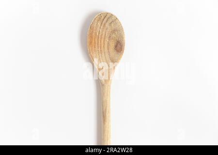 Wooden kitchen utensils. Wooden spoon used in the kitchen isolated over white background. Top view. Stock Photo
