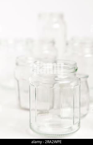 Assorted set of glass containers without lids on white background, recycling. Concept of second life to materials, various uses for glass vials. Stock Photo