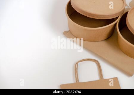 Set of card and paper elements related to packaging and transport of ready-to-eat food placed on a white background. Conceptual image of food delivery Stock Photo