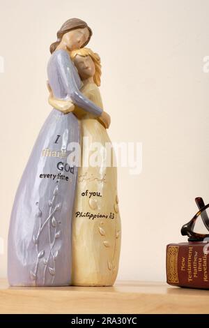 Christian themed ceramic ornament of a mother and daughter hugging, inscribed with 'I thank God every time I think of you Philippians 1:3'. Stock Photo