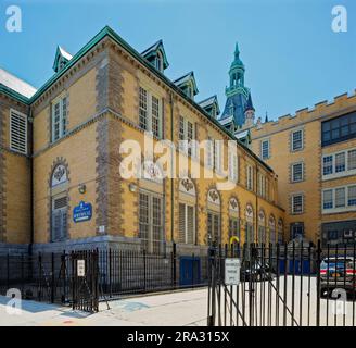 Newtown High School in Queens, NY, was built in stages: Flemish Revival main building and wings in 1921 and 1931; International Style wing in 1958. Stock Photo