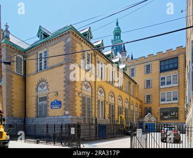 Newtown High School in Queens, NY, was built in stages: Flemish Revival main building and wings in 1921 and 1931; International Style wing in 1958. Stock Photo