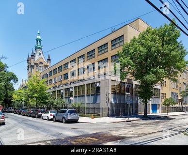 Newtown High School in Queens, NY, was built in stages: Flemish Revival main building and wings in 1921 and 1931; International Style wing in 1958. Stock Photo