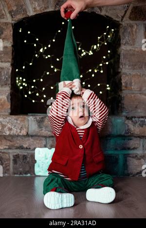 Baby boy dressed as elf at christmas time Stock Photo