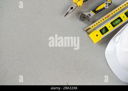 Hard hat safety helmet and working tools for construction site worker, engineer or contractor. Flat lay composition with copy space. Stock Photo