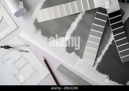 Home floor plans projects and grayscale color palette guide catalog with colour swatches and painted test paint samples. Interior design concept. Stock Photo
