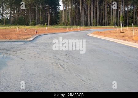 Flat road gravel subbase in new construction residential subdivision Stock Photo