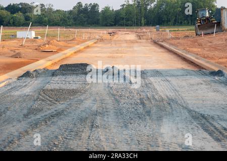 Flat road gravel subbase in new construction residential subdivision Stock Photo