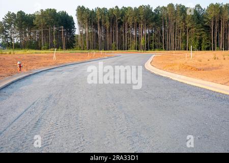 Flat road gravel subbase in new construction residential subdivision Stock Photo