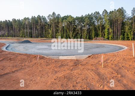 Flat road gravel subbase in new construction residential subdivision Stock Photo