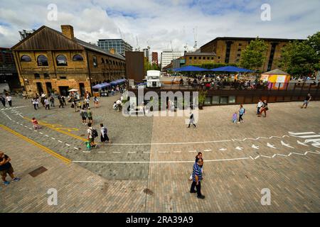 Coal Drops Yard in London is a redeveloped coal yard turned into an open air market with shops, outdoor movie theatre, restaurants and bars. Stock Photo