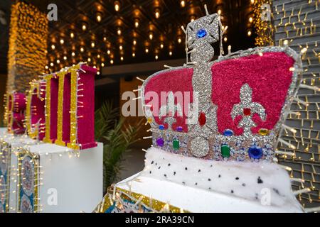 Coronation week in London, King Charles III coronation decorations at London hotel. King's Crown and royal symbol decorate busy London Bankside street Stock Photo